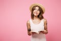 Portrait of a smiling thoughtful girl in summer hat