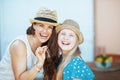 Portrait of smiling trendy mother and daughter tourists in hats Royalty Free Stock Photo