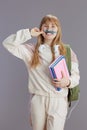 Portrait of smiling trendy young woman in beige tracksuit Royalty Free Stock Photo