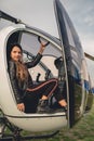 Smiling tween girl sitting on copilot seat in helicopter