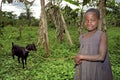 Portrait of smiling Ugandan goatherd with goat Royalty Free Stock Photo