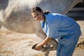 Portrait of smiling vet examining horse hoof at barn Royalty Free Stock Photo