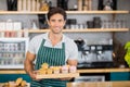 Portrait of smiling waiter holding a tray of cupcakes Royalty Free Stock Photo