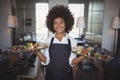 Portrait of smiling waitress holding food tray