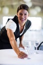 Portrait of smiling waitress setting the table Royalty Free Stock Photo