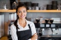 Portrait of smiling waitress standing with arms crossed Royalty Free Stock Photo