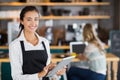 Portrait of smiling waitress using digital tablet Royalty Free Stock Photo