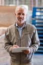 Portrait of smiling warehouse manager holding a clipboard Royalty Free Stock Photo