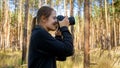 Portrait of smiling wild nature female photographer making photograph on digital camera at forest Royalty Free Stock Photo