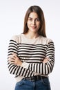 Close-up of confident young woman with folded arms against white background Royalty Free Stock Photo