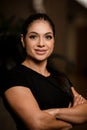 Portrait of smiling woman in black T-shirt with her arms crossed on her chest. Royalty Free Stock Photo