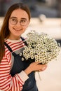 portrait of smiling woman with bouquet of fresh white small daisies. Royalty Free Stock Photo