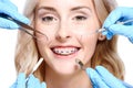 Hands holding dentist tools near woman