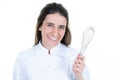 Portrait of smiling woman chef with hand beater on white background