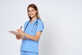 Portrait of smiling woman doctor taking notes making medical with clipboard isolate over white background Royalty Free Stock Photo