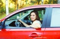 Portrait smiling woman driver behind wheel red car Royalty Free Stock Photo