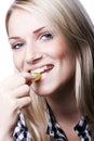 Portrait of a smiling woman eating a green grape Royalty Free Stock Photo