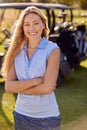 Portrait Of Smiling Woman Golfer Standing By Buggy On Golf Course Royalty Free Stock Photo