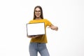 Portrait of a smiling woman holding blank screen laptop computer and showing ok isolated over white background Royalty Free Stock Photo