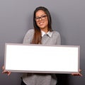 Portrait of smiling woman holding blank sign board.Studio portrait of young woman with sign card against gray background Royalty Free Stock Photo