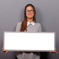 Portrait of smiling woman holding blank sign board.Studio portrait of young woman with sign card against gray background Royalty Free Stock Photo