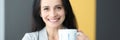 Portrait of smiling woman holding cup in her hand Royalty Free Stock Photo