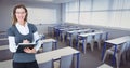 Portrait of smiling woman holding diary in classroom Royalty Free Stock Photo