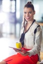 Portrait of smiling woman holding digital tablet in office Royalty Free Stock Photo