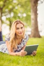 Portrait of smiling woman holding digital tablet at park Royalty Free Stock Photo