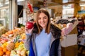 Portrait of smiling woman holding red apple