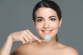 portrait of of smiling woman holding tooth brush with tooth paste