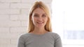 Portrait of Smiling Woman Looking at Camera in Office