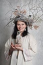 Portrait of a smiling woman with a meerkat in her hands