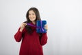 Portrait of a smiling woman opening a Christmas gift box with purple ribbon Royalty Free Stock Photo