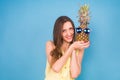 Portrait smiling woman and pineapple in sunglasses over blue background. Summer concept Royalty Free Stock Photo