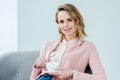 portrait of smiling woman in pink blouse with aromatic cup of coffee Royalty Free Stock Photo