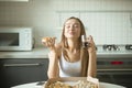 Portrait of a smiling woman with pizza in her hand