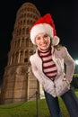 Portrait of smiling woman in Santa hat near Leaning Tower, Pisa Royalty Free Stock Photo