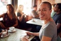 Portrait Of Smiling Woman Sitting At Table In Coffee Shop Royalty Free Stock Photo