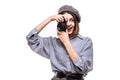 Portrait of a smiling woman wearing beret taking picture with a photo camera isolated over white background Royalty Free Stock Photo