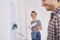 Portrait of smiling woman painting walls in her new home