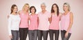 Composite image of portrait of smiling women supporting breast cancer social issue Royalty Free Stock Photo