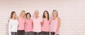 Composite image of portrait of smiling women supporting breast cancer social issue Royalty Free Stock Photo