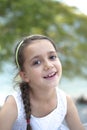 Portrait of a 7 year old girl sitting on a wall Royalty Free Stock Photo