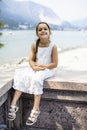 Portrait of a 7 year old girl sitting on a wall Royalty Free Stock Photo