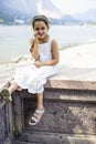 Portrait of a 7 year old girl sitting on a wall Royalty Free Stock Photo