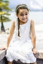 Portrait of a 7 year old girl sitting on a wall Royalty Free Stock Photo