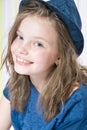 Portrait of a smiling 8 year old girl in a hat. Royalty Free Stock Photo