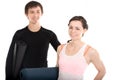 Portrait of smiling yogi couple with yoga mats