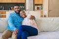 Smiling young African American couple relaxing together on their sofa Royalty Free Stock Photo